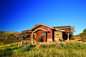 Boss-designed home with multiple reclaimed materials: red vertical siding - barnwood (not to be confused with the rusted metal applied vertically); horizontal siding - milled from mining timbers; fascia - barnwood; soffit - milled from pickle barrels